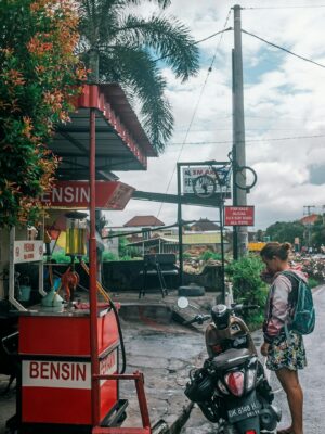 Woman with motorbike at gas station